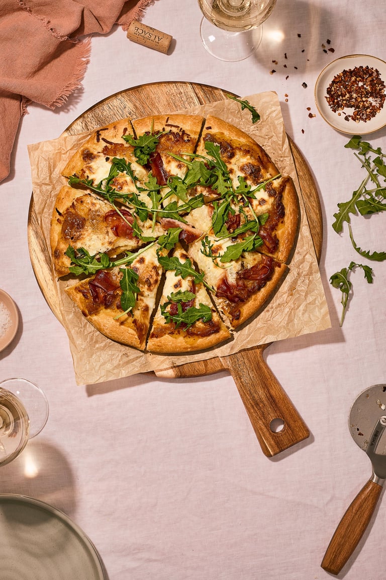 Artisanal pizza with prosciutto and arugula